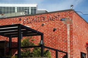 Los Angeles apartment for rent - A red brick building with a black awning and the words at Prizma in Los Angeles, CA, 90038