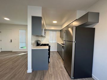 Los Angeles apartment for rent - A kitchen with a black refrigerator and a grey island.