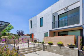 Santa Monica apartment for rent - A modern house with a concrete exterior and a balcony with a railing.at 810 Ashland, Santa Monica, 90405