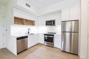 Los Angeles apartment for rent - A kitchen with white cabinets and stainless steel appliances.at The Dillon, California, 90026