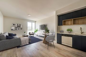 Los Angeles apartment for rent - A modern living room with a grey sofa and a grey chair.