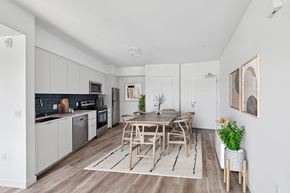 Los Angeles apartment for rent - A modern kitchen with a dining table and chairs.at The Jayne, Los Angeles, 90016