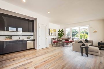 Los Angeles apartment for rent - A modern kitchen with dark brown cabinets and a white countertop.