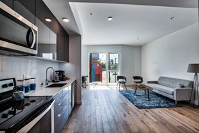 Los Angeles apartment for rent - A modern kitchen with a wooden floor and a large window.at 5263 W Adams, Los Angeles, CA 90016