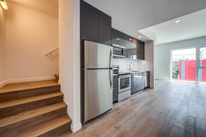 Los Angeles apartment for rent - A modern kitchen with a refrigerator, microwave, and oven.at 5263 W Adams, Los Angeles, 90016