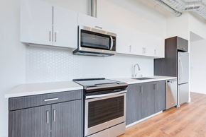 Los Angeles apartment for rent - A modern kitchen with a stainless steel oven and microwave.at 2231 S Western, Los Angeles