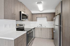 Los Angeles apartment for rent - A modern kitchen with wooden cabinets and stainless steel appliances.at Hollywood Ardmore, Los Angeles, CA 90028