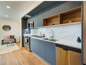 Los Angeles apartment for rent - A modern kitchen with a stainless steel dishwasher and a marble backsplash at Prizma in Los Angeles, CA, 90038