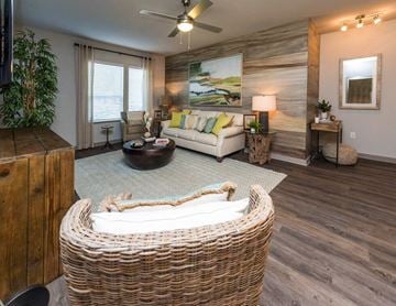 Savannah apartment for rent - A living room with a wicker sofa and a painting on the wall.
