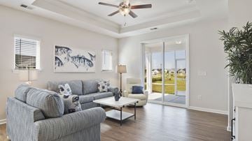 Little River apartment for rent - A living room with a grey couch and a painting on the wall.