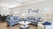 Little River apartment for rent - A living room with a grey couch, a white armchair, and a coffee table at Stepping Stone at Bridgewater Apartments, Little River, South Carolina