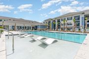 Little River apartment for rent - A large swimming pool in front of a building with palm trees. at The Banks at Bridgewater Apartments, South Carolina, 29566