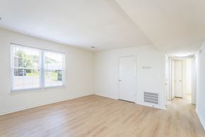 Strasburg apartment for rent - A room with wooden floors and white walls.
