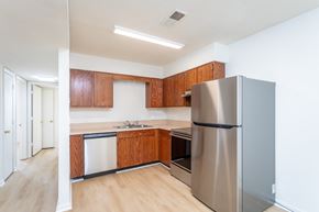 Strasburg apartment for rent - A kitchen with a refrigerator, sink, and cabinets.