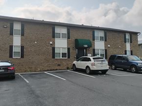 Strasburg apartment for rent - A parking lot in front of a building with the number 195 on it.