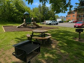 Manassas apartment for rent - A playground with a slide and a picnic table.