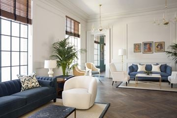 San Francisco apartment for rent - A living room with a dark blue couch and a white chair.