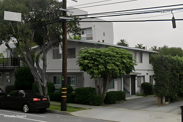 Los Angeles apartment for rent - A black car is parked on the side of a street.