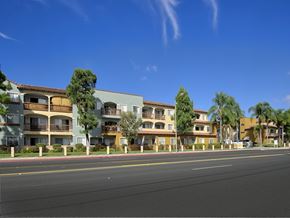 Huntington Beach apartment for rent - A row of apartment buildings with trees in front of them.