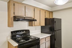 Tempe apartment for rent - A kitchen with a black stove and black refrigerator.