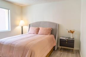 Tempe apartment for rent - A bedroom with a bed, nightstand, and lamp.