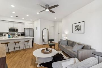 Tempe apartment for rent - A modern living room with a grey couch and a white coffee table.