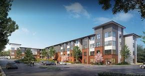 Nashville apartment for rent - A modern apartment complex with multiple buildings and a parking lot in front.