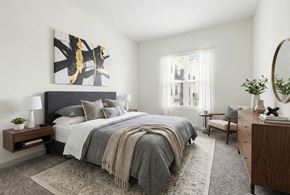 Hermitage apartment for rent - A bedroom with a large bed and a painting on the wall.