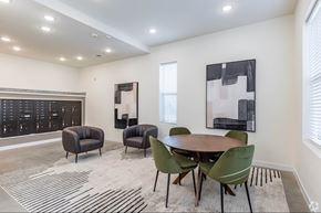 Brentwood apartment for rent - A modern dining room with a wooden table and green chairs.