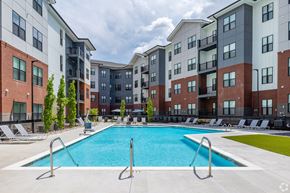 Hermitage apartment for rent - A swimming pool in front of apartment buildings.