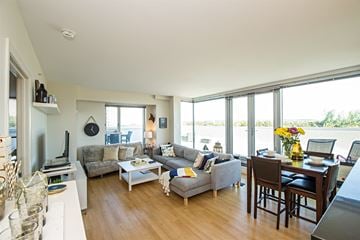 Halifax apartment for rent - A living room with a grey couch and a wooden floor.