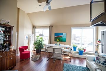 Halifax apartment for rent - A living room with a red chair and a white couch.