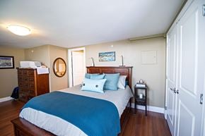 Halifax apartment for rent - A bedroom with a bed, nightstand, and dresser.