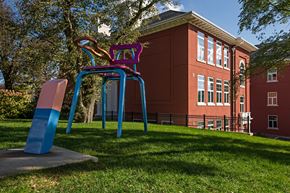 Dartmouth apartment for rent - A playground with a blue and pink slide in front of a red building.