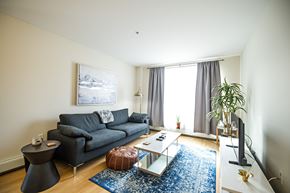 Halifax apartment for rent - A living room with a grey couch, a coffee table, and a painting on the wall.
