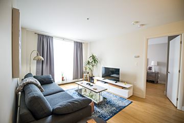 Halifax apartment for rent - A living room with a grey couch and a white coffee table.