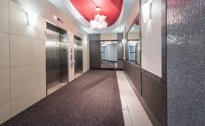 Halifax apartment for rent - A long hallway with a red ceiling and a carpeted floor.