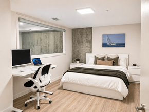 Halifax apartment for rent - A bedroom with a bed, desk, and chair.