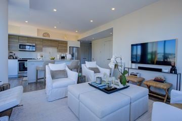Halifax apartment for rent - A modern living room with a white sofa set and a television.