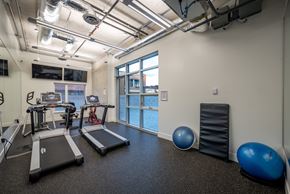 Halifax apartment for rent - A gym with treadmills, exercise balls, and a weight machine.