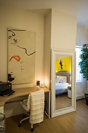 Dartmouth apartment for rent - A large mirror reflects a bedroom with a bed and a plant.