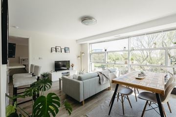 Halifax apartment for rent - A living room with a couch, a chair, a table and a television.