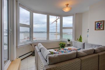 Halifax apartment for rent - A living room with a couch and a view of the beach.