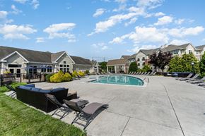 Camp Hill apartment for rent - A swimming pool surrounded by lounge chairs and apartment buildings.