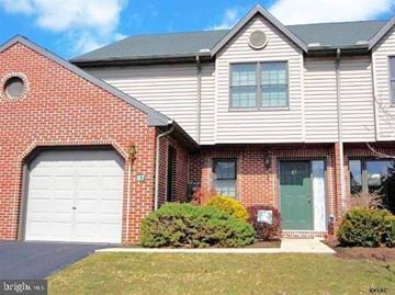 York apartment for rent - A house with a garage door and a green door.