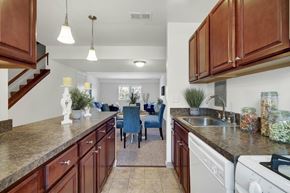 York apartment for rent - A kitchen with brown cabinets and a white stove top oven.