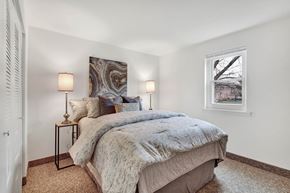 Wrightsville apartment for rent - A bedroom with a large bed and two lamps on either side of the bed.
