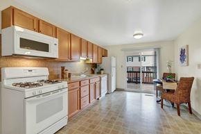Wrightsville apartment for rent - A kitchen with white and brown cabinets and a white stove.