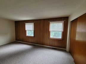 Dallastown apartment for rent - A room with two windows and a carpeted floor.