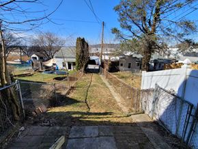 Red Lion apartment for rent - A backyard with a fence and a tree.